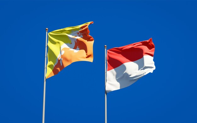 Hermosas banderas del estado nacional de Indonesia y Bután juntos en el cielo azul