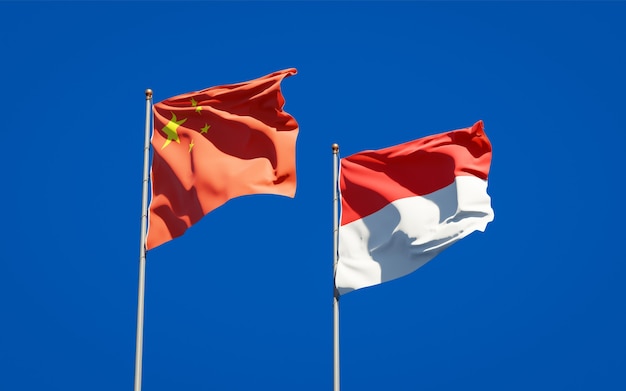 Hermosas banderas del estado nacional de Indonesia y China juntos en el cielo azul