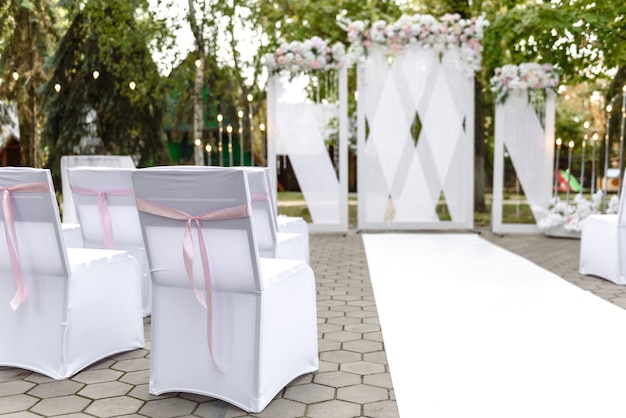 Hermosas composiciones florales en el restaurante para la ceremonia de la boda. Ceremonia solemne de pintar al novio y a la novia