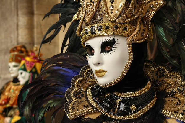 Foto hermosas y fantásticas máscaras y disfraces de elegantes y magníficos diseños en el carnaval de venecia