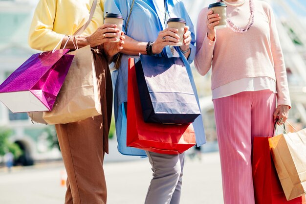 Hermosas mujeres mayores felices de compras en el centro de la ciudad