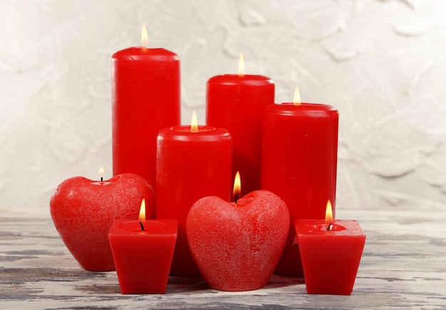 Hermosas velas en la mesa sobre fondo gris