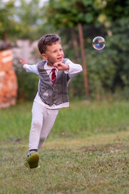 Foto hermoso bebé con burbujas de jabón infantil posando fotógrafo para una foto genial