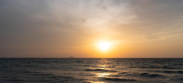 Hermoso cielo de amanecer con vista romántica a la playa por la mañana