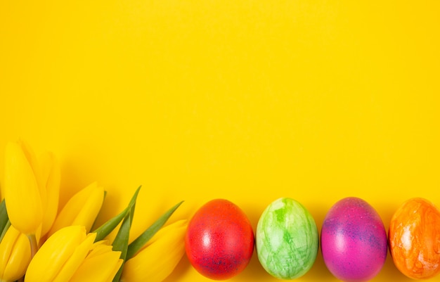 Hermoso grupo de huevos de Pascua en la primavera del día de pascua, huevos rojos, azules, morados y amarillos