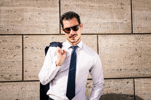 Foto el hermoso hombre de negocios está haciendo una llamada de negocios con su teléfono inteligente