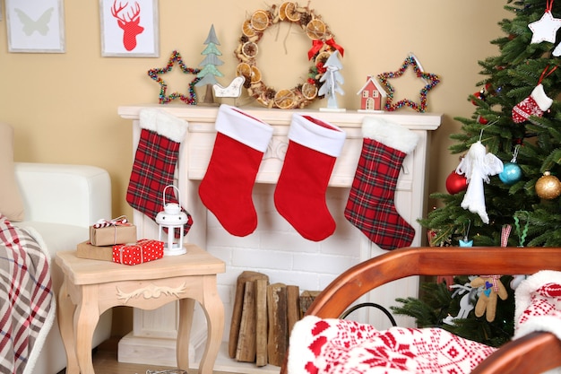 Hermoso interior de Navidad con sofá, chimenea decorativa y abeto