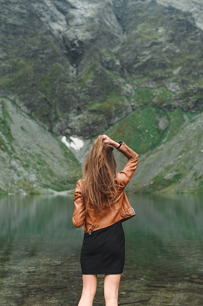 Hermoso paisaje de montaña y lago con mujer