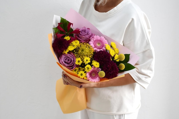 Hermoso ramo de flores en manos de una foto de mujer para postal y catálogo de una tienda de flores en línea entrega de flores frescas