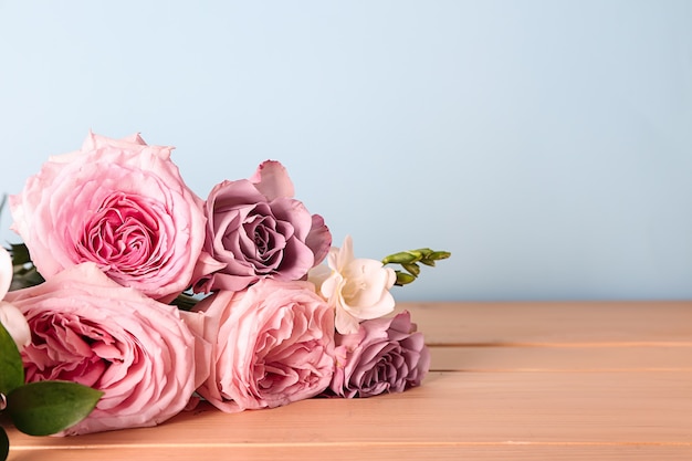 Hermoso ramo de rosas en la mesa de madera