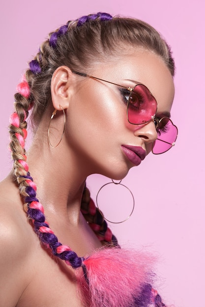 Hermoso retrato de una joven. Maquillaje y peinado profesional de trenzas de colores