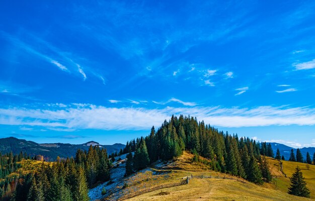 Hermosos bosques coloridos que cubren las montañas de los Cárpatos y un pequeño pueblo