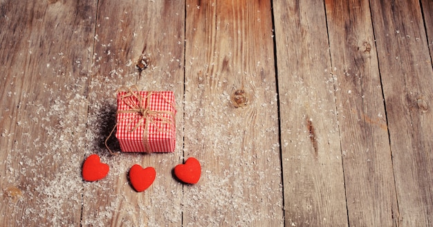 Herz auf einem hölzernen Hintergrund mit Schnee. Valentinstag. Valentinstag Grußkarte.