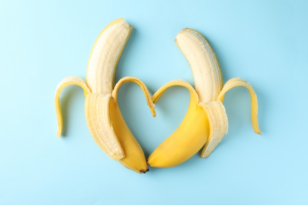 Herz aus Bananen auf blauem Hintergrund. Frisches Obst