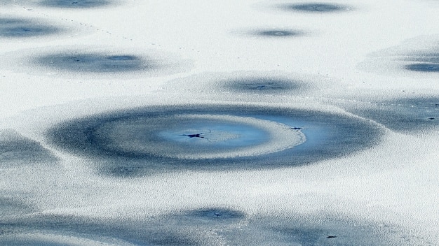 Hielo cubierto de nieve con grietas