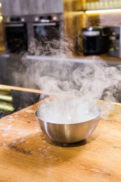 Hielo seco de vapor de humo en un recipiente en la cocina