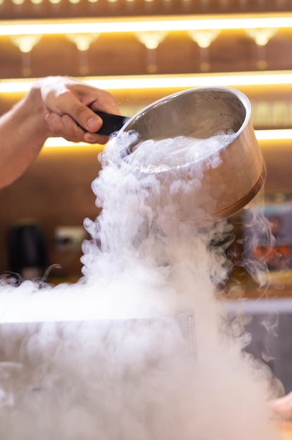 Hielo seco de vapor de humo en un recipiente en la cocina