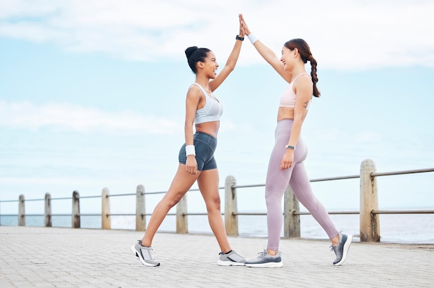 High Five Fitness und Frauentraining in der Stadt mit Unterstützung für Körperziel Gesundheit und Wellness Junge glückliche und aufgeregte Läuferfreunde mit Motivation für Laufsport und Outdoor-Training