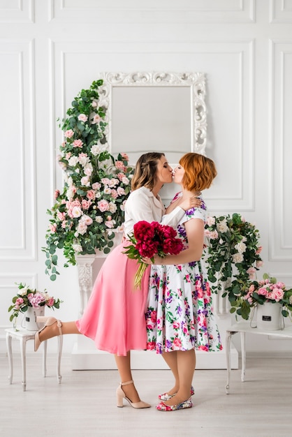 Foto hija feliz dando a la madre un ramo de flores de primavera