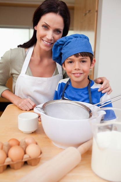 Hijo y madre preparando pastel