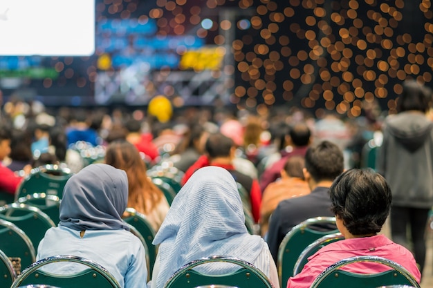 Hintere Ansicht des Publikums im Konferenzsaal oder in der Seminarbesprechung, die Sprecher haben