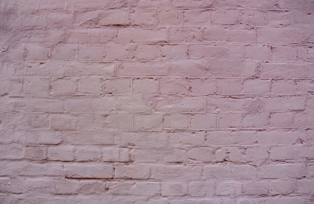 Hintergrund der alten Backsteinmauer mit Farbe oder Putz bedeckt