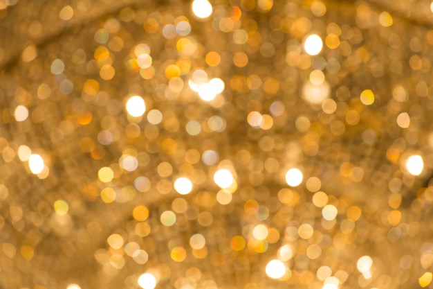 Hintergrund der funkelnden, defokussierten und verschwommenen, abstrakten Bokeh-goldgelben Farbe mit Glitzerkreisen ohne Menschen