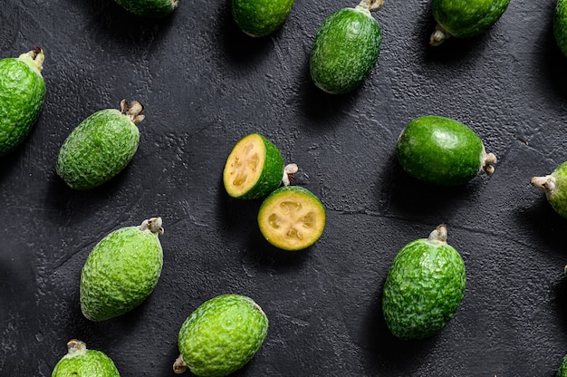 Hintergrund der grünen Feijoa. Schwarzer Hintergrund. Ansicht von oben.