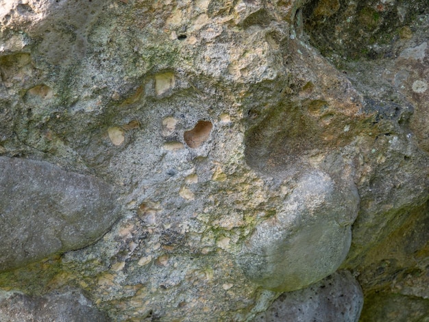 Hintergrund der unebenen Stein Steinmauer Altes Mauerwerk Überreste der Architektur