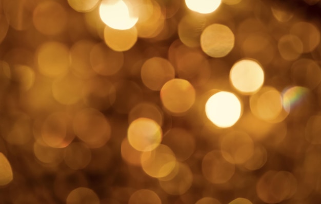 Hintergrund des goldenen defokussierten hellen Bokeh