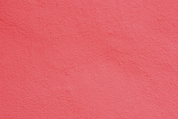 Hintergrund eines rosa Stucks beschichtete und malte Äußeres, raue Form der Zement- und Betonmauerbeschaffenheit