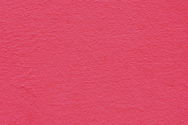 Hintergrund eines rosa Stucks beschichtete und malte Äußeres, raue Form der Zement- und Betonmauerbeschaffenheit