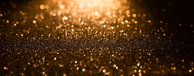 Hintergrund von goldenen und schwarzen Glitzerlichtern Defokussierter abstrakter Hintergrund