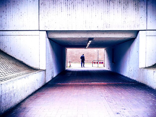 Foto hintergrundansicht eines silhouettenmannes, der im tunnel läuft