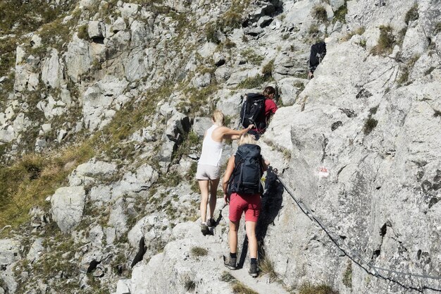 Foto hintergrundansicht von menschen, die an der via ferrata heini-holzer-klettersteig merano auf felsen klettern