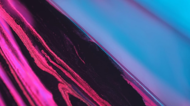 Hintergrundfarbenflüssigkeit Mischung Glitzer blau rosa Flüssigkeit