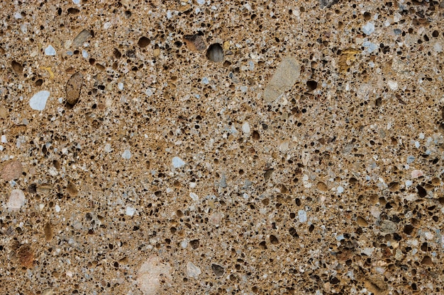 Hintergrundstruktur des Konglomeratsteins mit vielen Poren und Löchern.