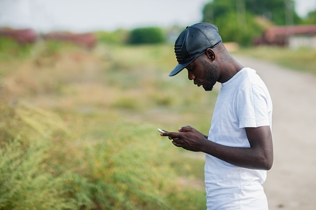 Hippie, ein junger Mann, der einen Smartphone verwendet.