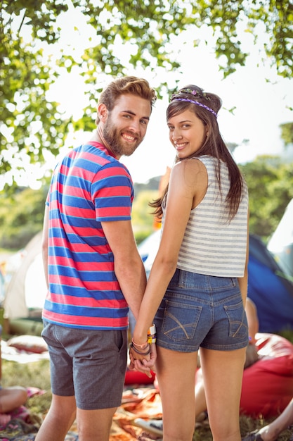 Hippie-Paarhändchenhalten auf Campingplatz