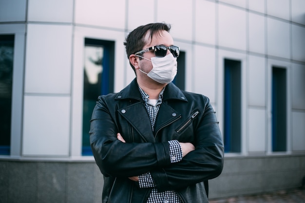 Hipster Mann, der eine Schutzmaske von Coronavirus trägt