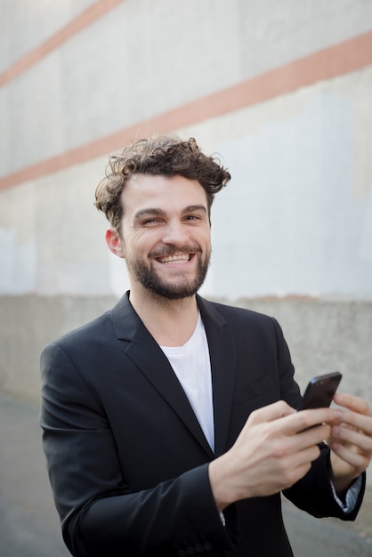 hipster moderno homem bonito usando telefone inteligente