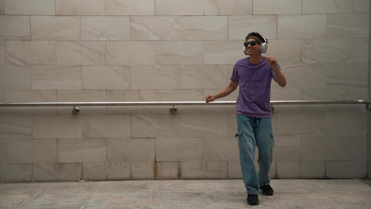 Foto hipster ouvir música enquanto se move ou dançar com a música na sala de dança animadamente
