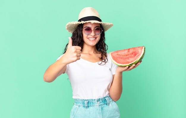 Hispanische hübsche Touristenfrau, die eine Wassermelone hält