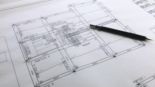 Foto hochwinkelansicht des stifts auf dem bauplan