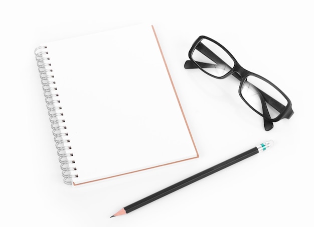 Hochwinkelansicht eines Buches mit Bleistift und Brille auf weißem Hintergrund