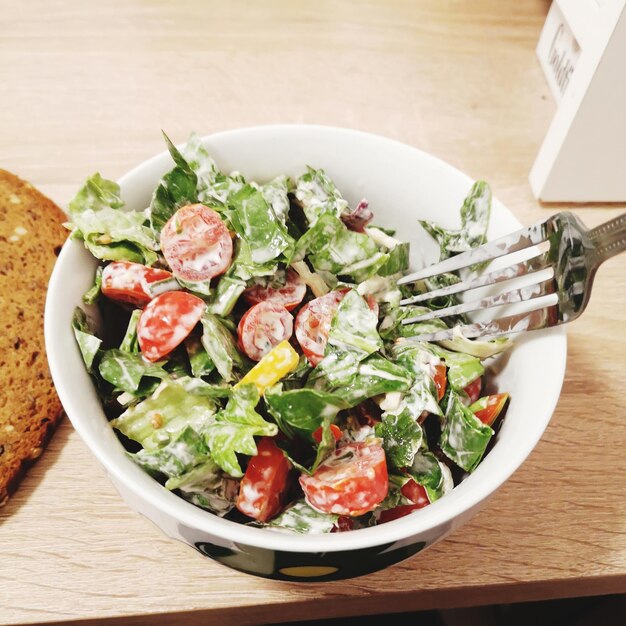 Foto hochwinkelansicht von salat in einer schüssel auf dem tisch