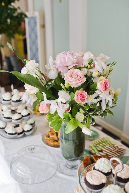 Hochzeitsessen im Restaurant, Tische mit Rosenvasen dekoriert.
