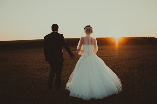 Hochzeitspaar mit dem Sonnenuntergang