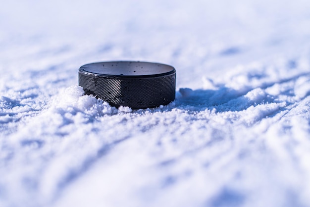 Foto hockeypuck liegt auf der schneenahaufnahme