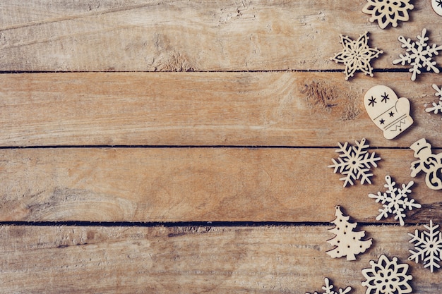 Hölzerner brauner Weihnachtshintergrund mit Schneeflocken und Weihnachtsdekoration.